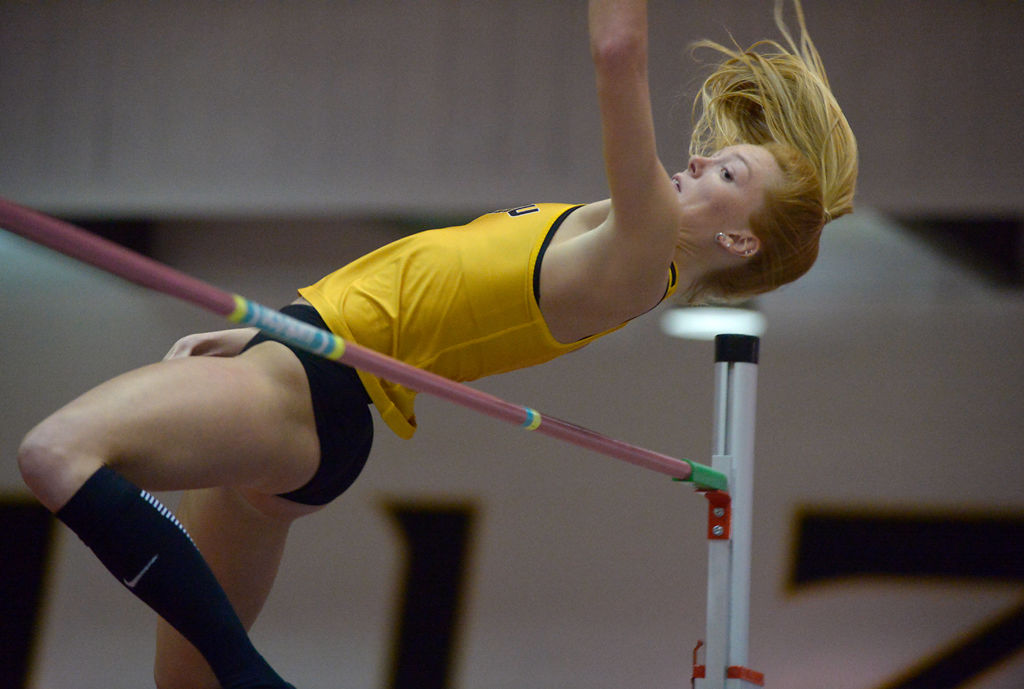Karissa Roman jumps over the pole during the women's high jump Friday, Dec. 6, 2019